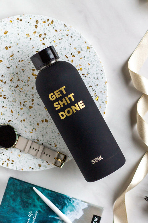 2. SEIK black thermos with motivational 'Get Shit Done' text, displayed on a terrazzo surface with accessories
