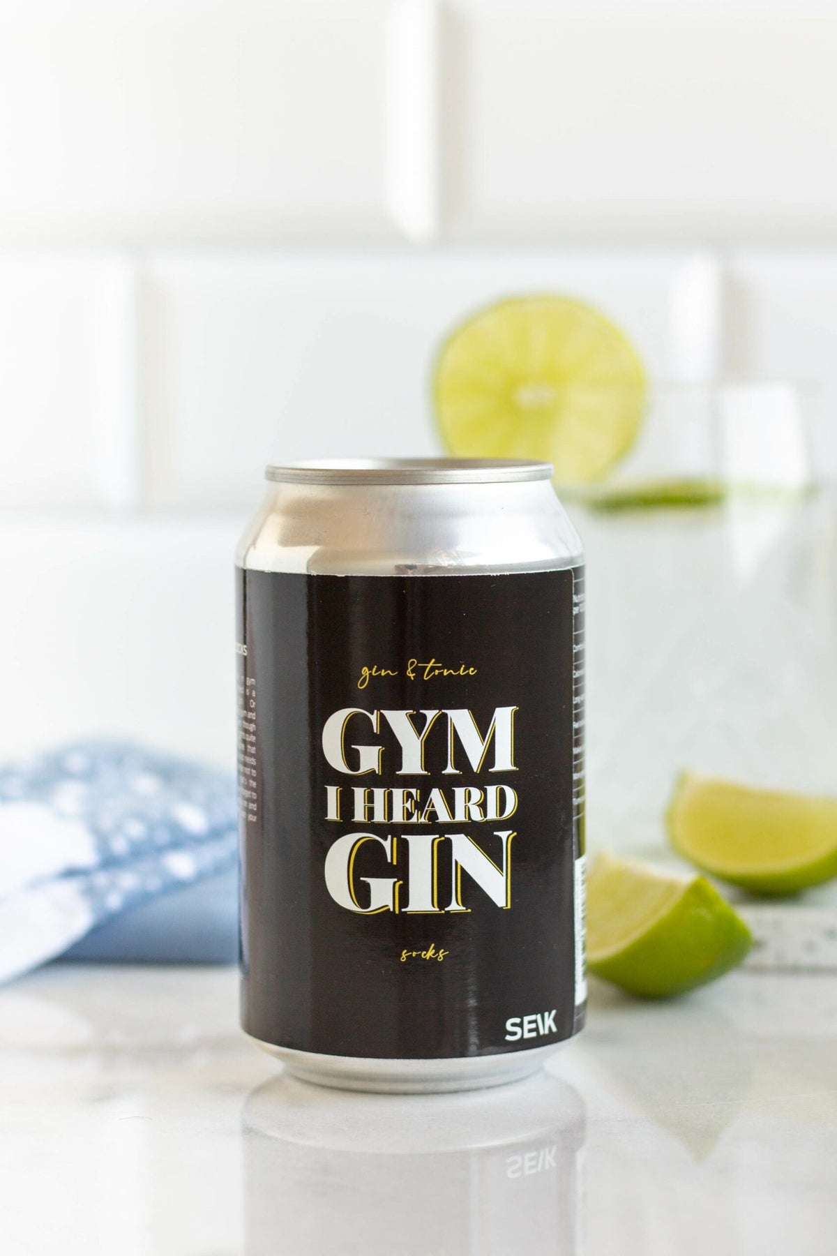 6. SEIK 'Gym I Heard Gin' can with socks, lime, and drink, highlighting fun design