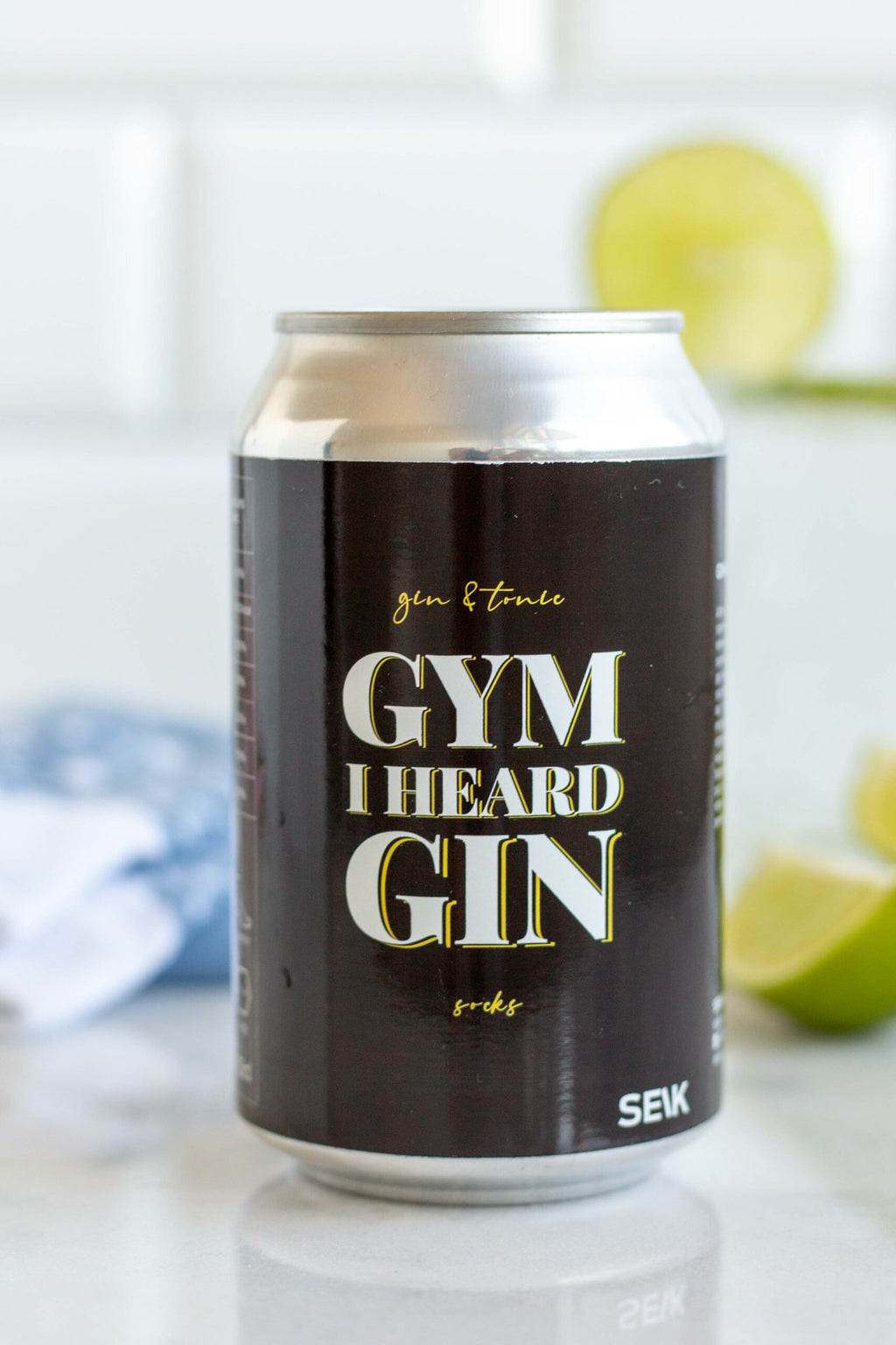 4. SEIK 'Gym I Heard Gin' can with socks, lime, and drink in lifestyle setting