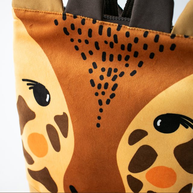 9. Close-up of Muni giraffe backpack, focusing on giraffe face and fabric details