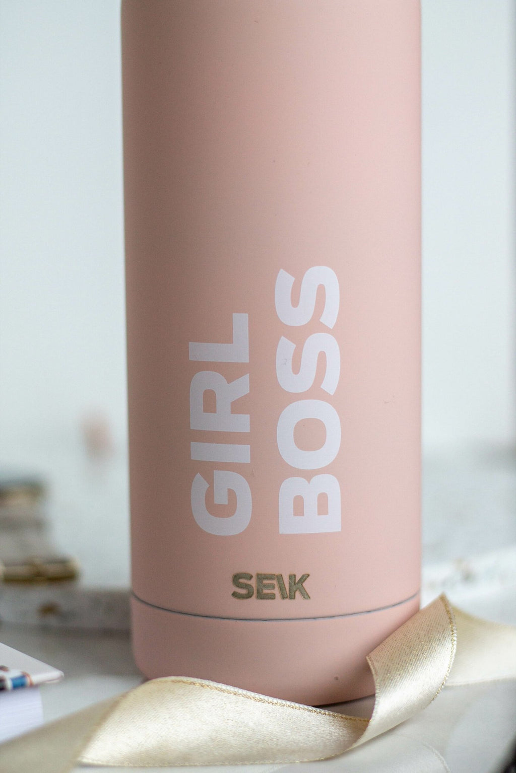 5. Close-up of SEIK Girl Boss branding on pink stainless steel water bottle