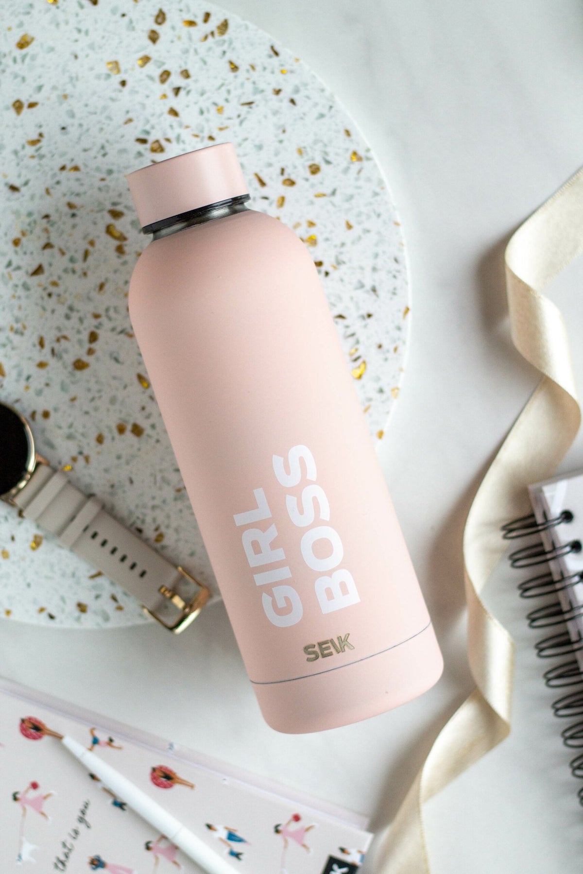 4. SEIK Girl Boss water bottle in pink, styled with desk accessories for a modern aesthetic
