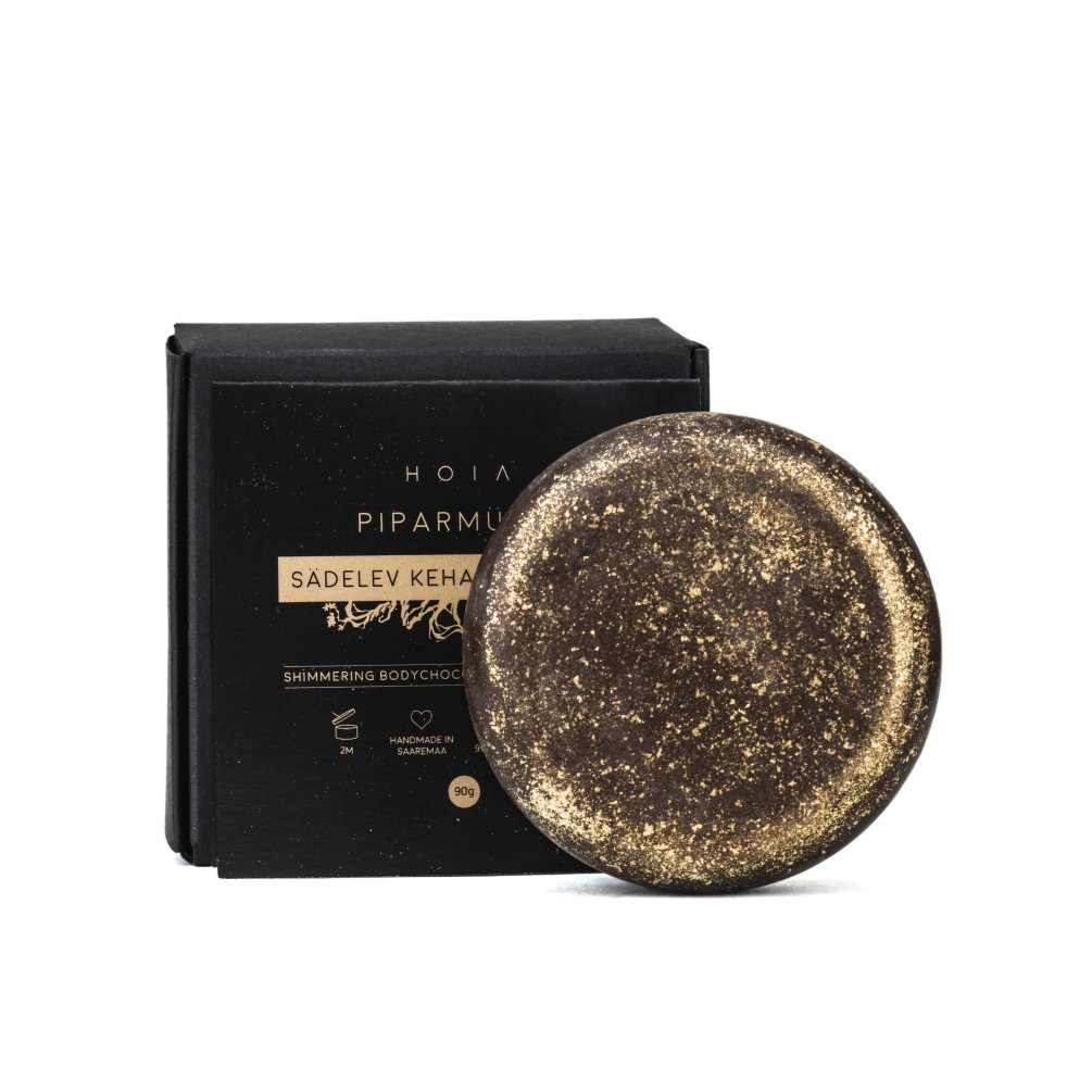 4. Studio image of HOIA homespa Shimmering Body Chocolate with packaging, showing its sparkling texture