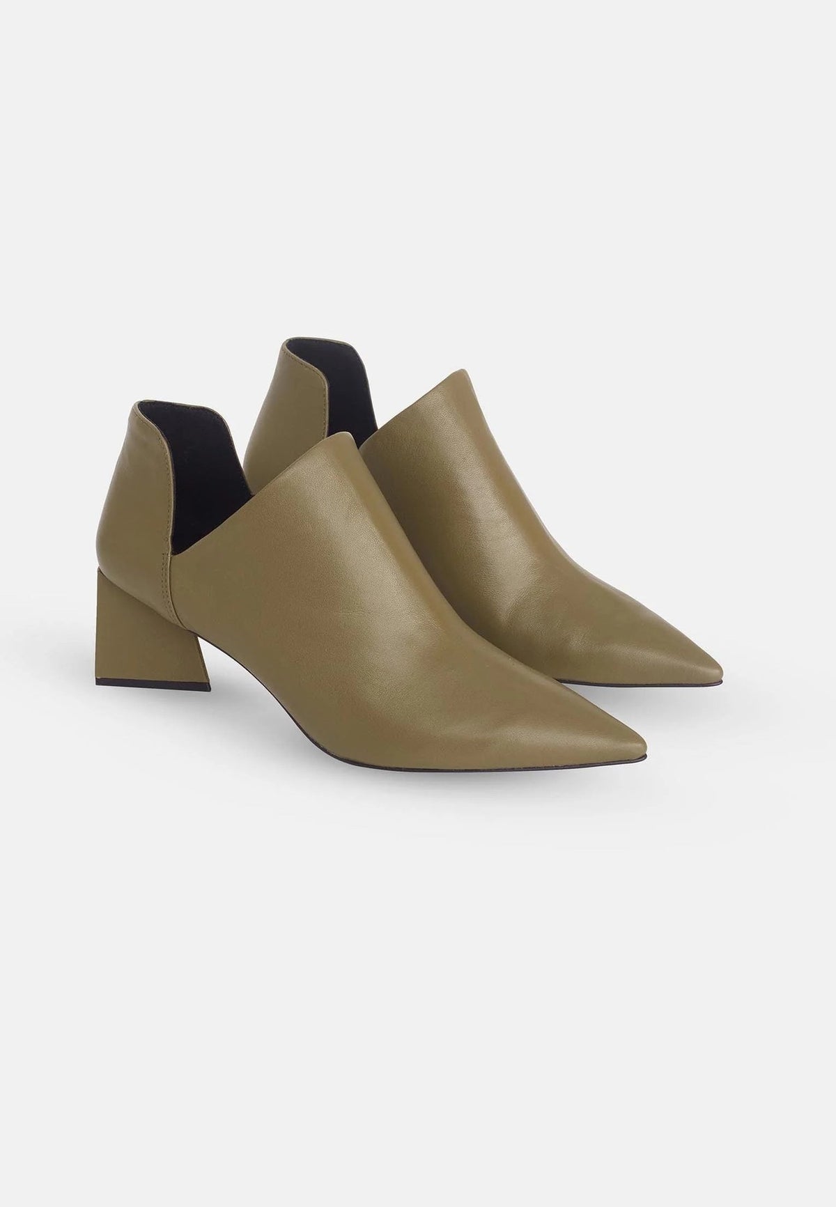 3. Pair of green sheepskin leather ankle boots with pointed toe and block heel shown in three-quarter view on white background
