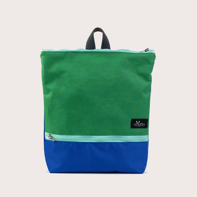 5. Angled studio view of Muni waterproof kids backpack in green and blue, highlighting design