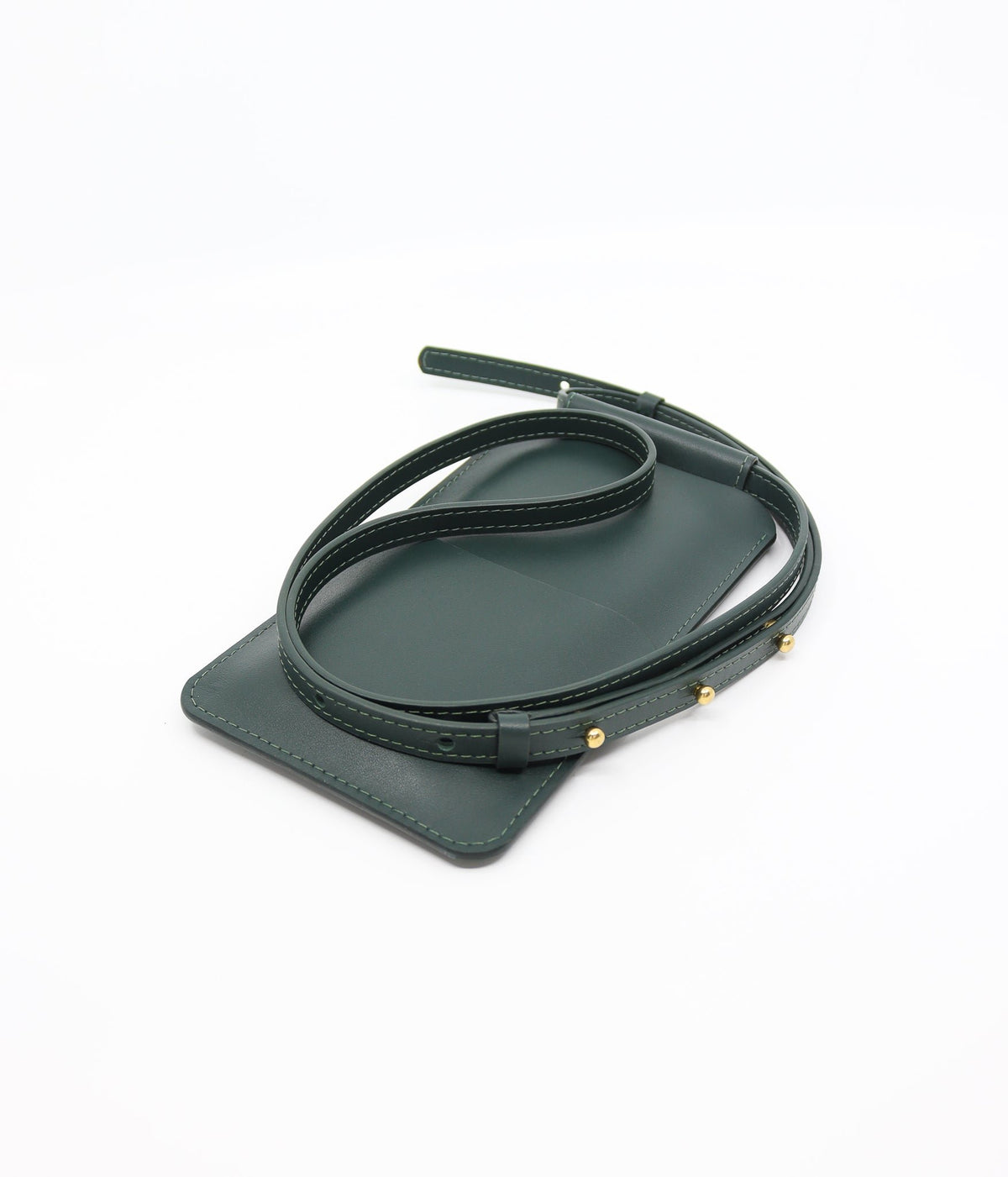 4. Close-up of Tairi Roosve leather phone bag in forest green, highlighting strap and gold Sam Browne buttons