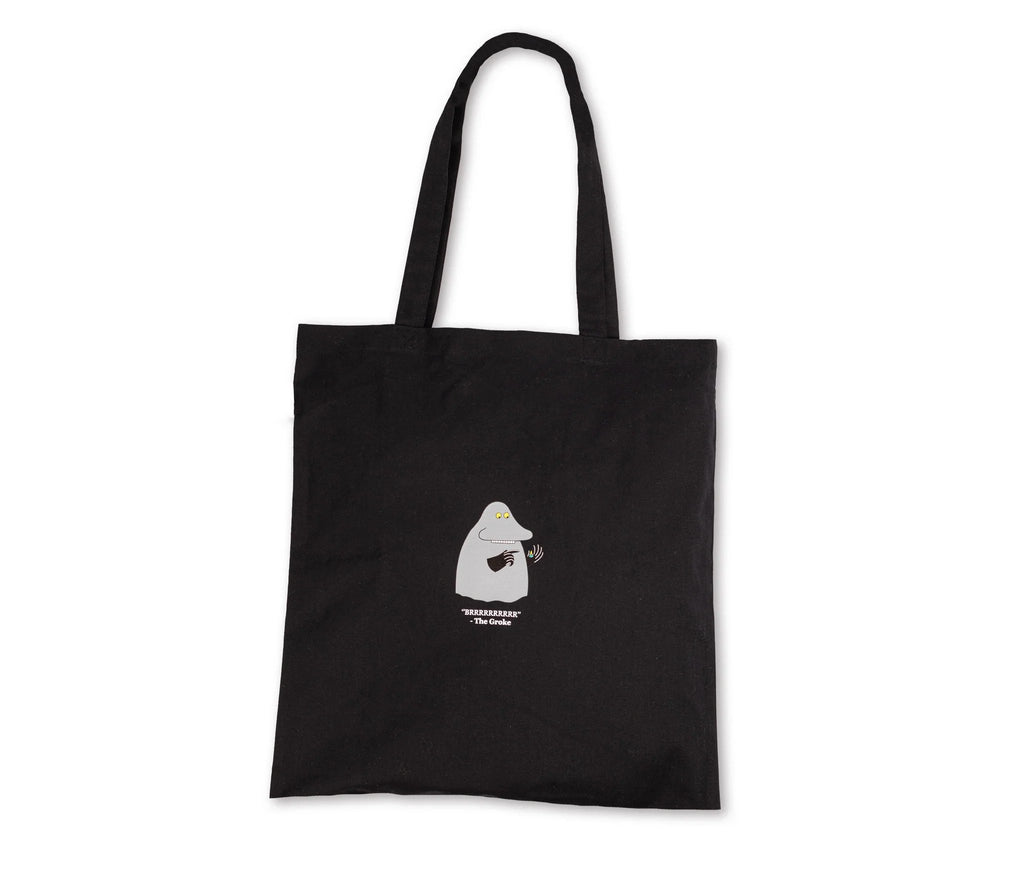 4. Flat lay of black Moomin The Groke tote bag, showing front design and sturdy handles