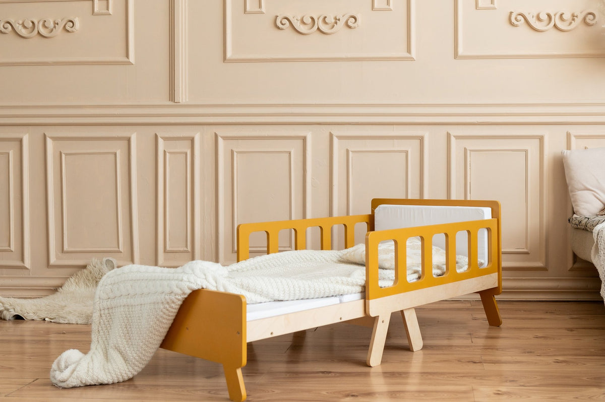 3. Yellow growing bed for kids with white bedding in classic room with wooden paneling