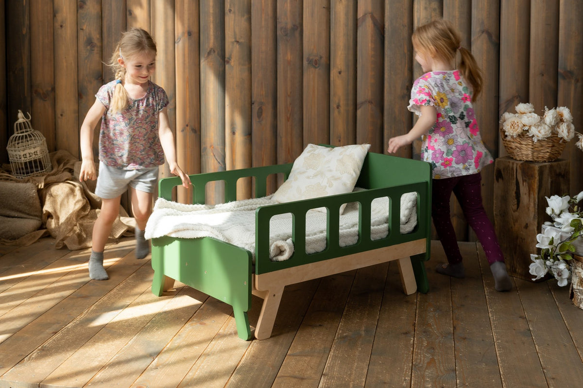 4. Two children playing near green growing bed in rustic wooden room