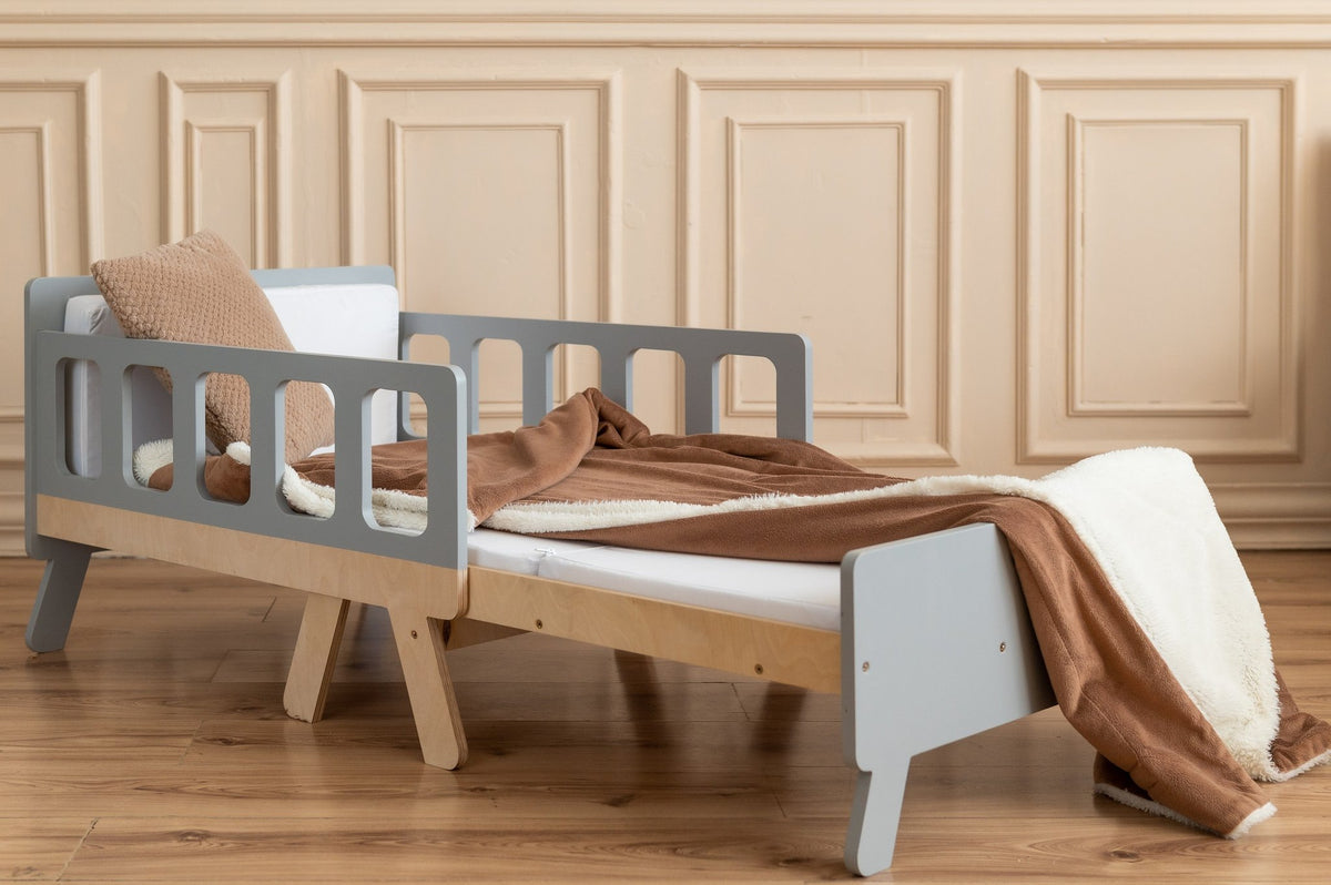 1. Grey and white growing bed for kids with brown blanket in elegant room with wooden flooring