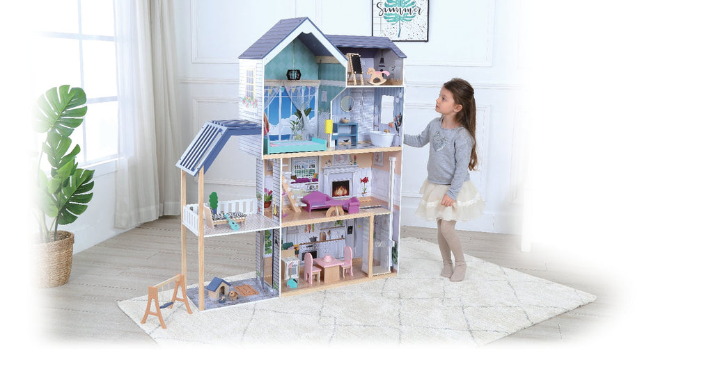 1. Young girl interacting with Gerardo's Toys wooden dollhouse Crystal, showcasing four floors, LED lights, and detailed interior in a living room
