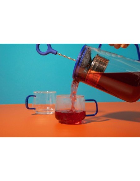 1. Pouring tea from La Cafetière Gyro teapot into glass cups, vibrant background