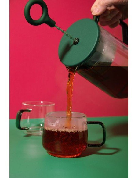 8. Pouring tea from La Cafetière Gyro Teapot into glass cup with red background