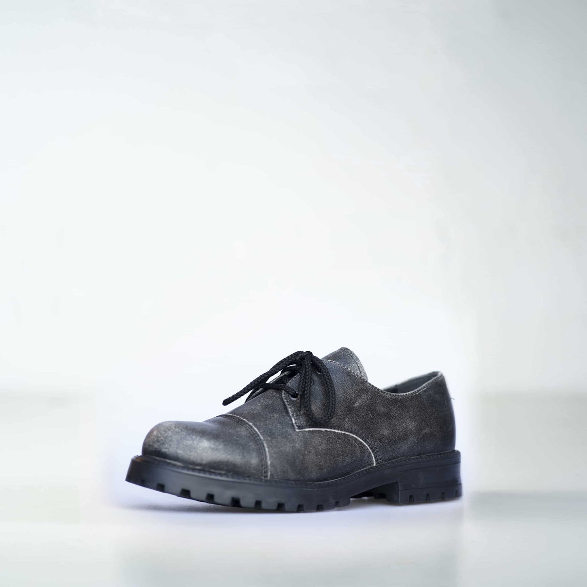 1. Unisex Antique Widgets sneaker by Samelin in studio setting, showcasing genuine leather upper and direct-injected PU outsole