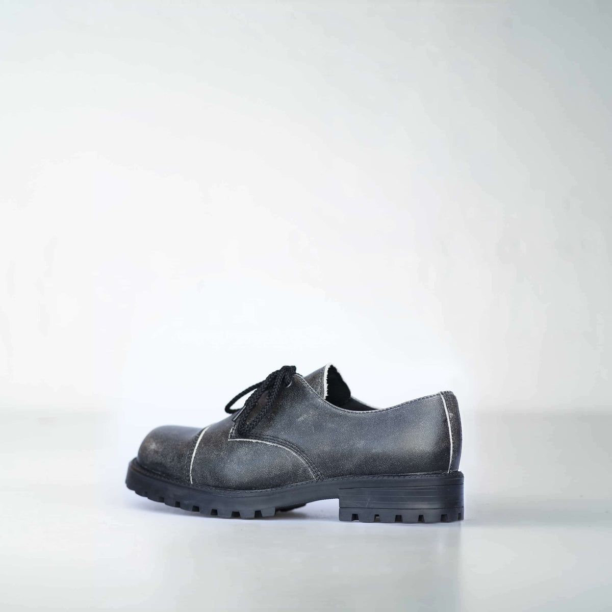 2. Side view of Samelin's Antique Widgets unisex sneaker, highlighting military-grade quality and leather material