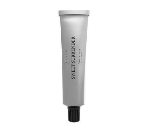 1. Silver aluminum tube of maar Sweet Surrender hand cream with black cap on white background