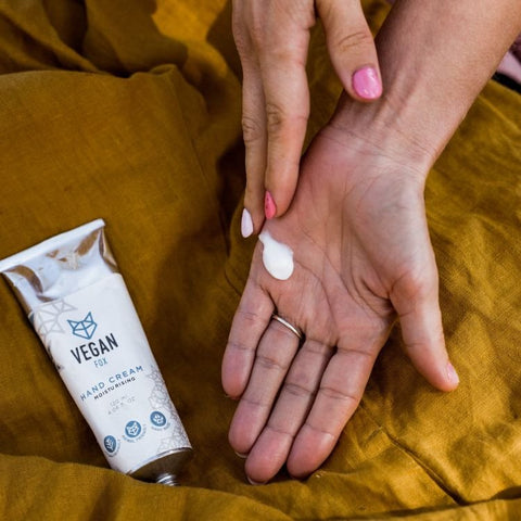 5. Woman applying Vegan Fox Hand Cream, demonstrating smooth texture and easy absorption