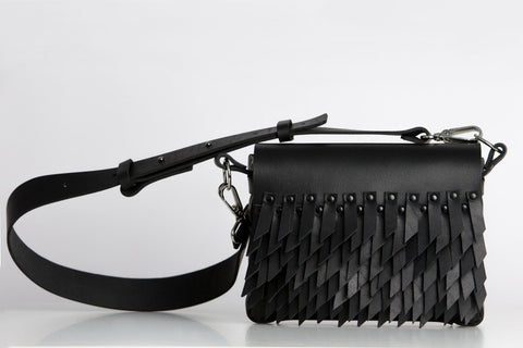 2. Studio shot of PYKOK BARBED SISTER handbag with leather strap and fringe design