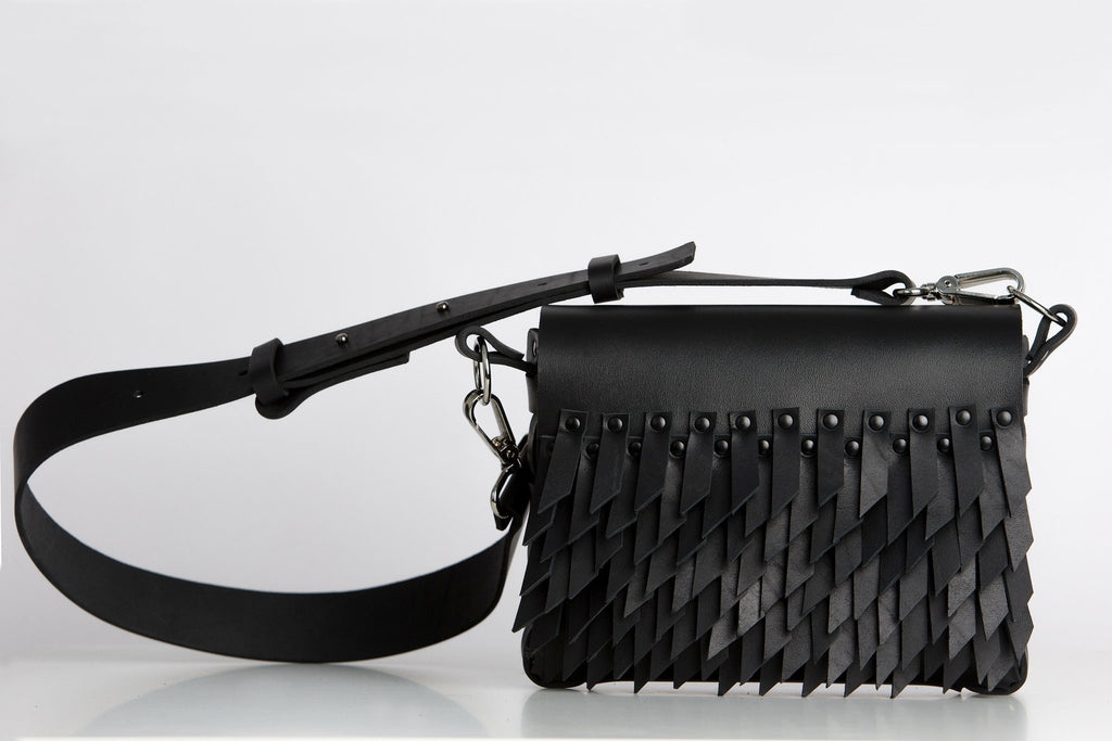 2. Studio shot of PYKOK BARBED SISTER handbag with leather strap and fringe design