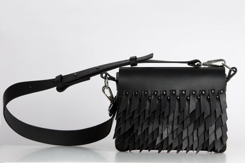 2. Studio shot of PYKOK BARBED SISTER handbag with leather strap and fringe design