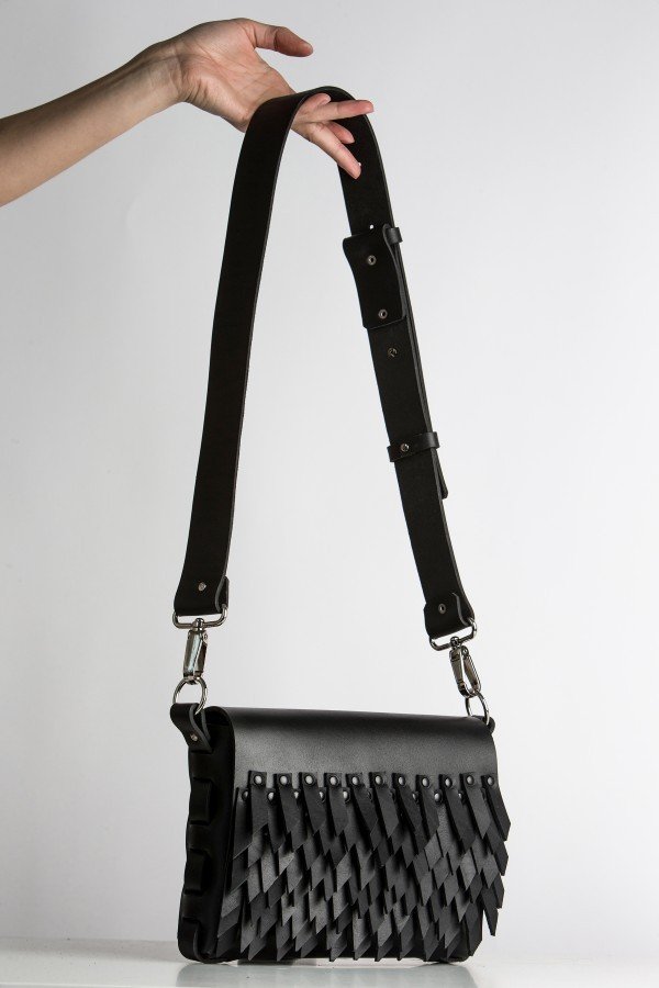 5. PYKOK BARBED SISTER handbag with leather strap held by hand against white background