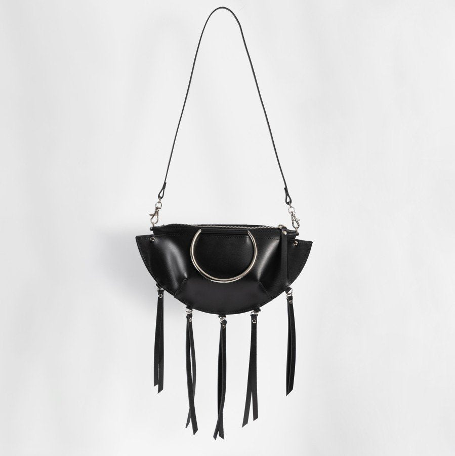 1. Black leather KAYA handbag with metal ring details and tassels, shown with a shoulder strap against a white background