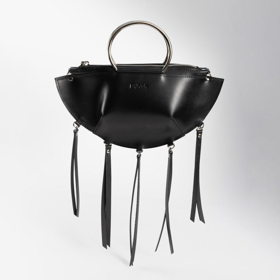 5. Black leather KAYA handbag with metal ring handles and tassels, shown upright against a white background