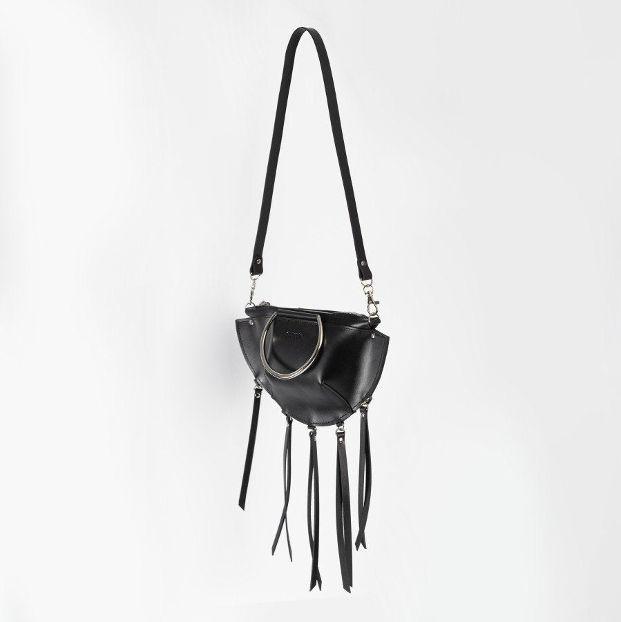 12. Black leather KAYA handbag with metal ring details and tassels, shown with a shoulder strap against a white background