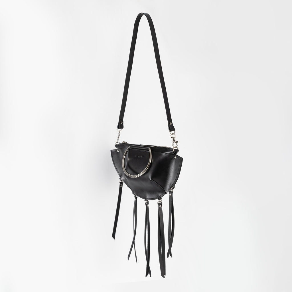 10. Black leather KAYA handbag with metal ring details and tassels, shown with a shoulder strap against a white background