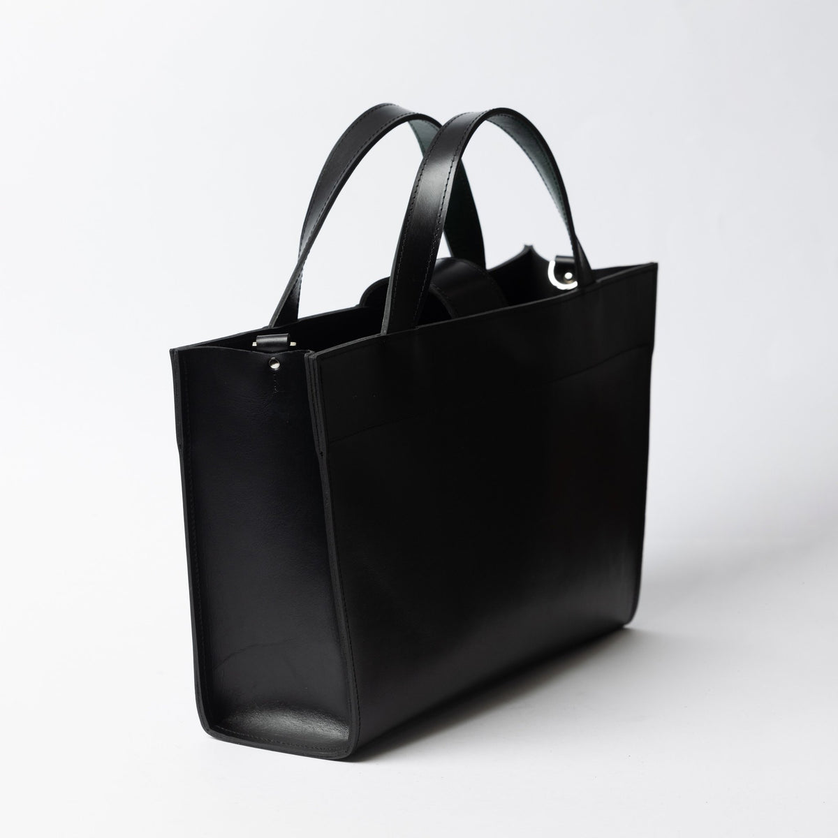 5. Side view of black leather MONIKA tote bag with dual handles