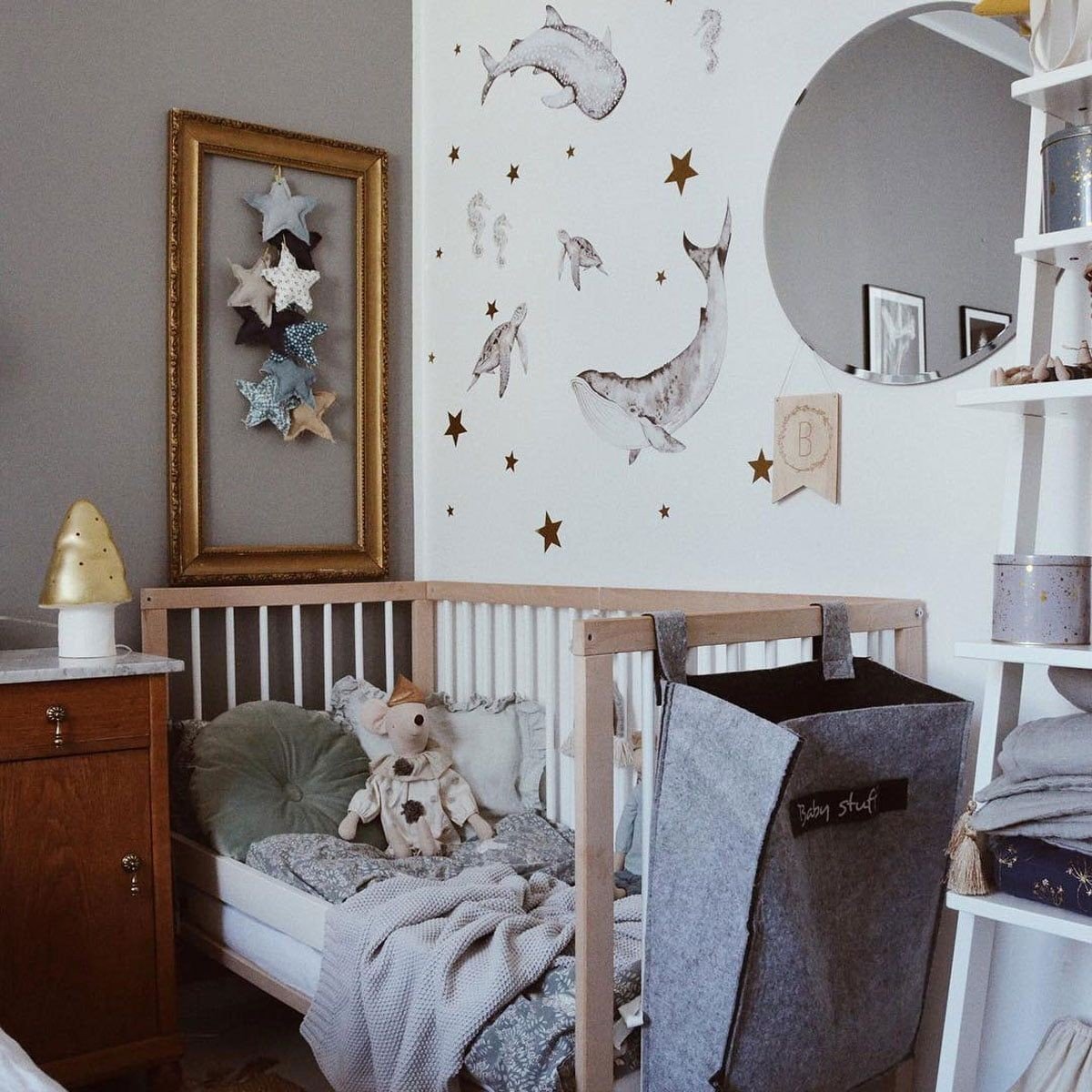 2. Nursery with Happy Ocean Wonderland wall stickers of marine animals and stars above a crib with plush toys and decor