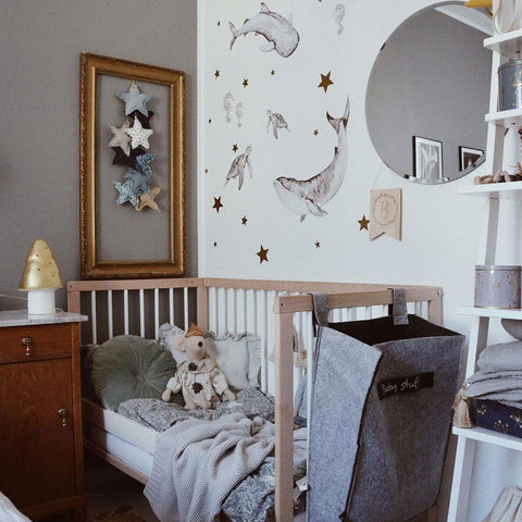 2. Nursery with Happy Ocean Wonderland wall stickers of marine animals and stars above a crib with plush toys and decor