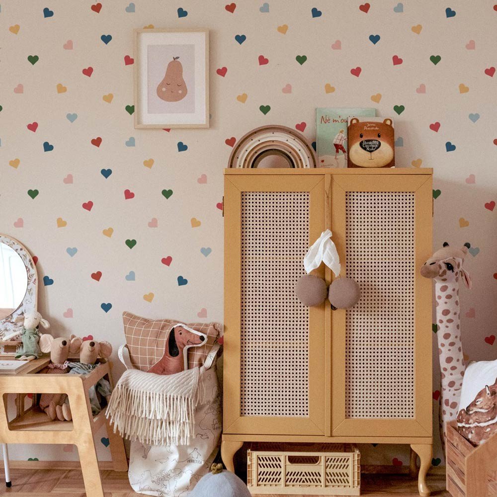 4. Children's room with Dekornik heart-patterned wallpaper, featuring a wicker cabinet, toys, and framed art