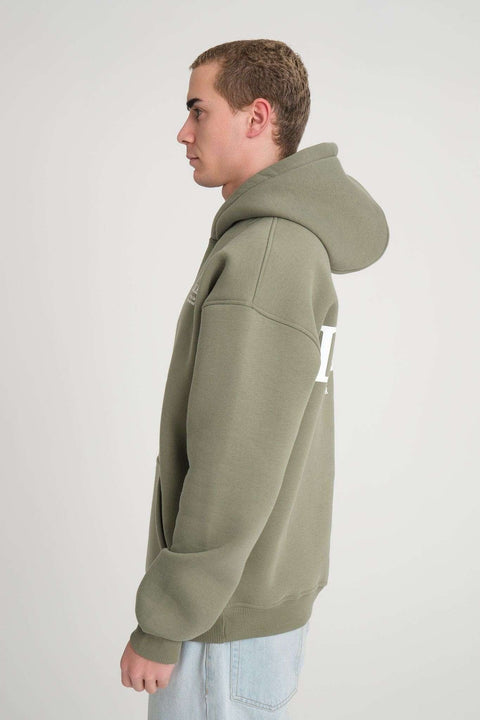 2. Side view of men's olive green hoodie with hood up, worn by model in studio setting