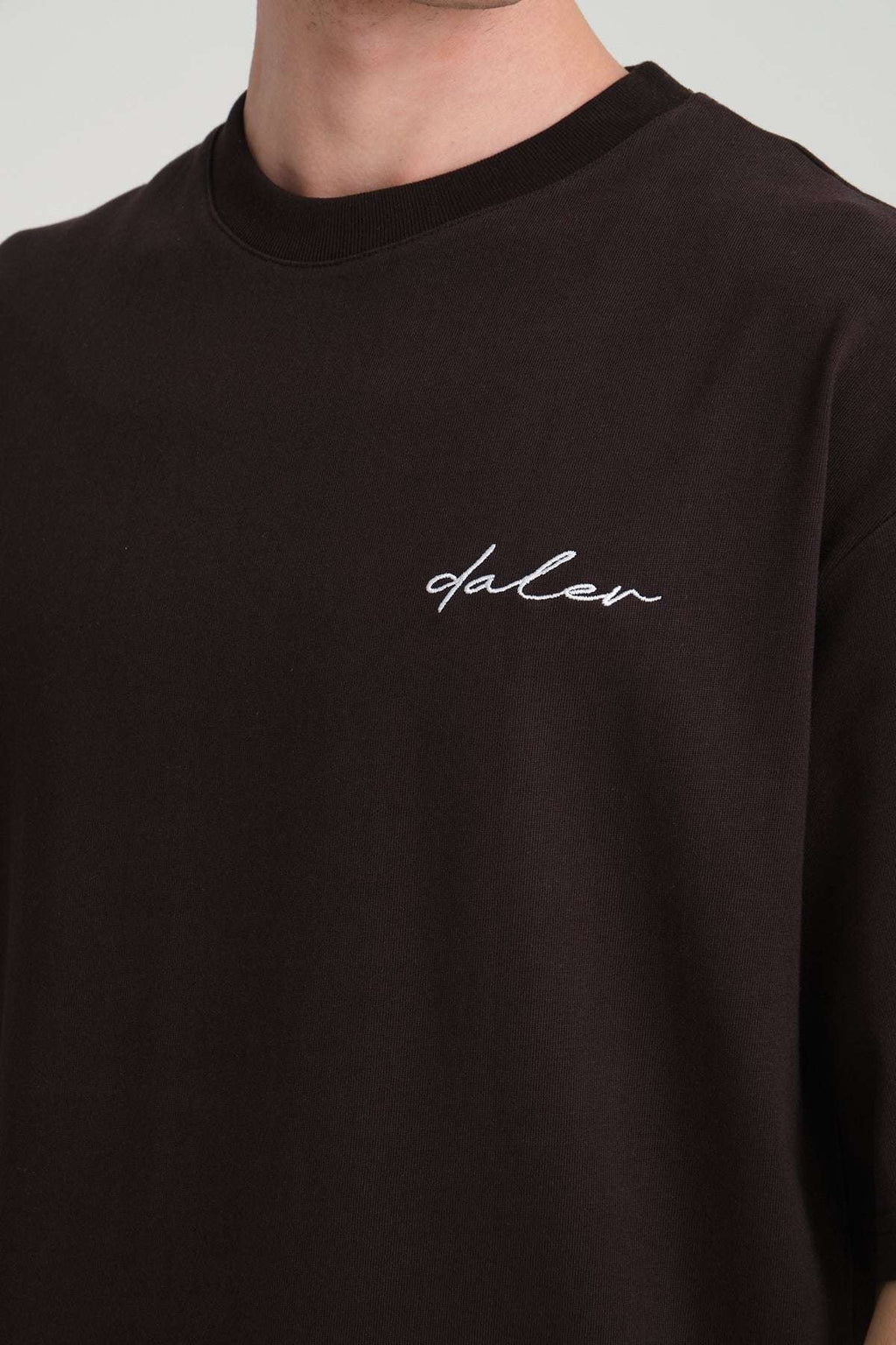 2. Close-up of black DalerClo t-shirt showing embroidered logo on chest