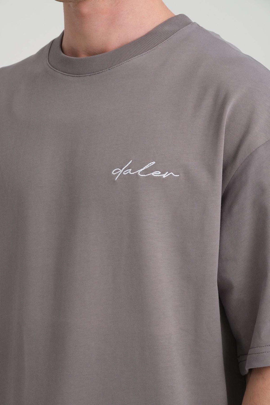 1. Close-up of grey heavyweight t-shirt with embroidered DalerClo logo on chest