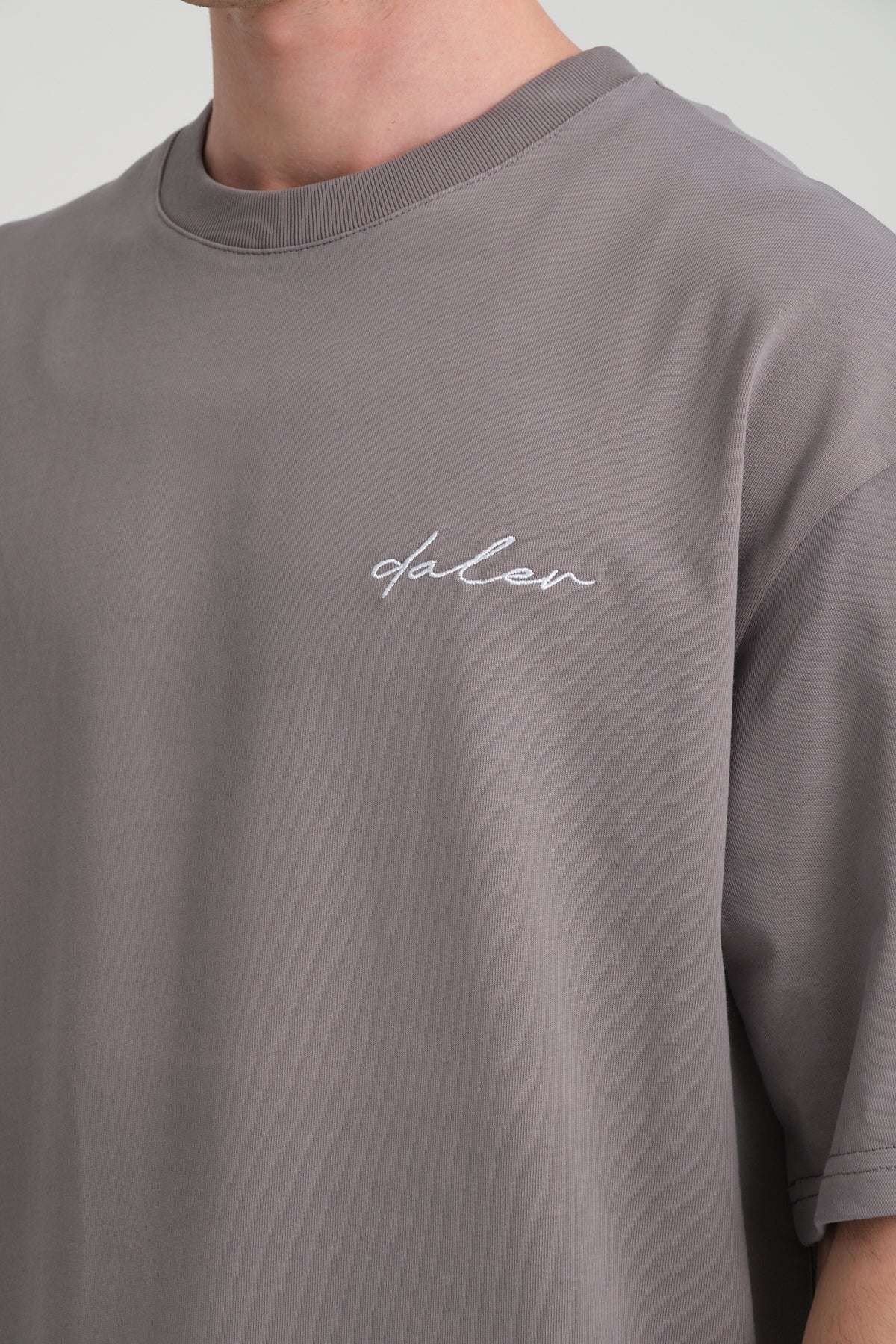 1. Close-up of grey heavyweight t-shirt with embroidered DalerClo logo on chest