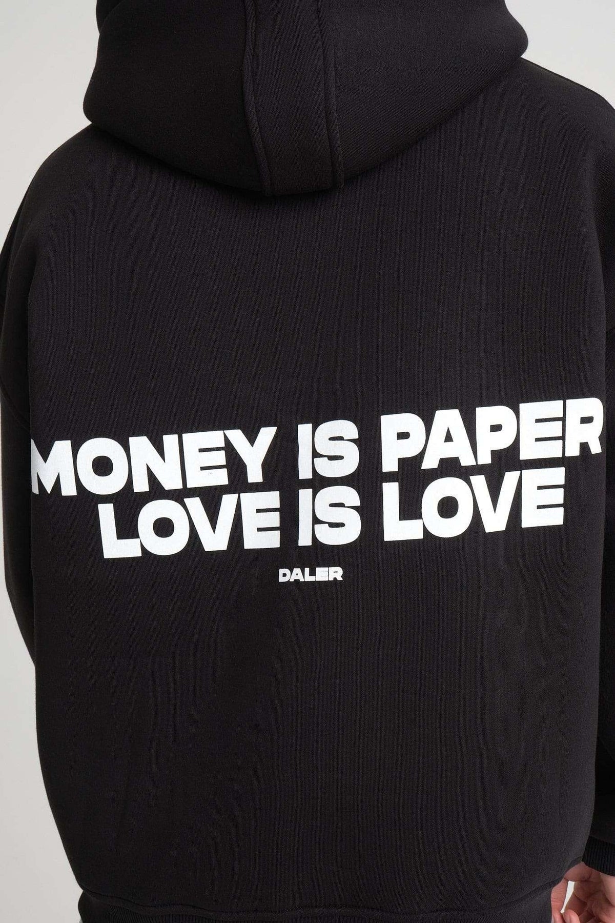 8. Close-up of back of black hoodie with 'Money is Paper, Love is Love' text, highlighting the bold design and DalerClo branding.