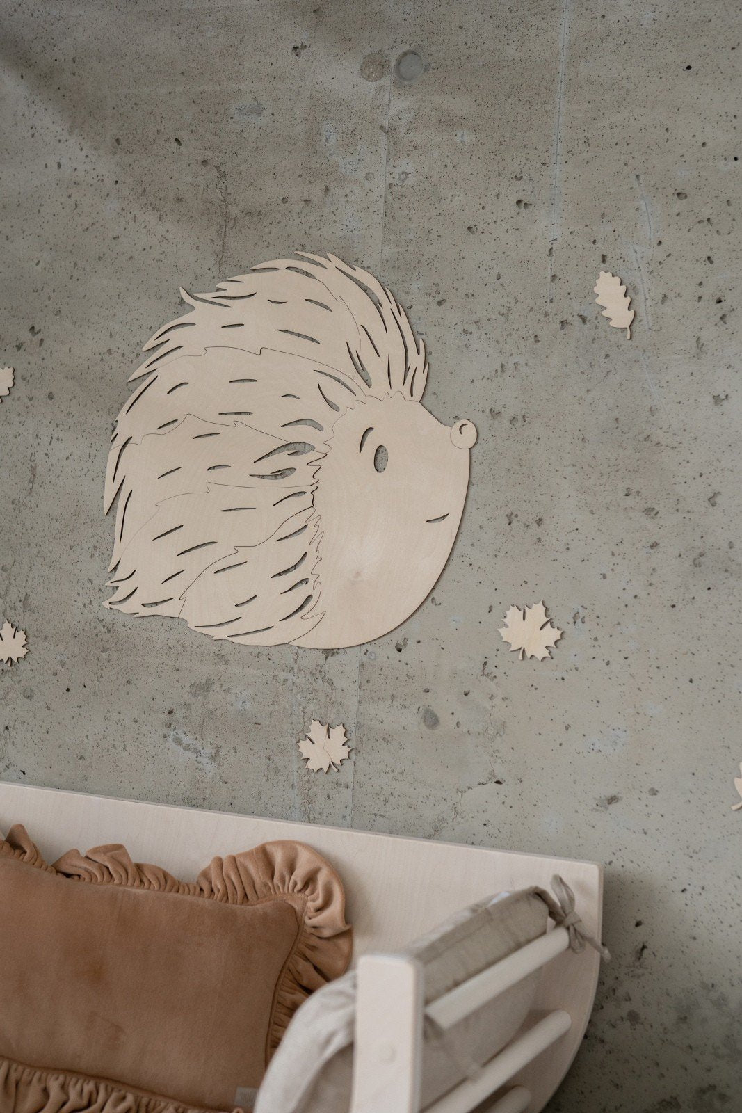 2. Close-up of birch plywood hedgehog wall decoration on textured wall