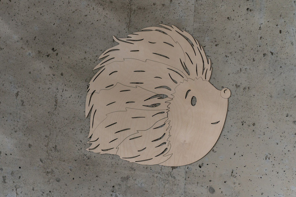5. Studio shot of birch plywood hedgehog wall decoration on concrete background