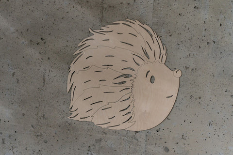 5. Studio shot of birch plywood hedgehog wall decoration on concrete background