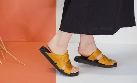 1. Women's Helsinki sandals in ocre by Omaking, worn by model in lifestyle setting