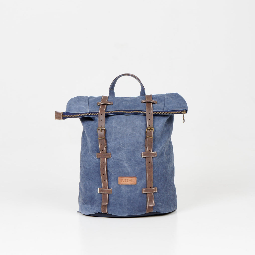 1. Noel ZIP Backpack in blue with leather straps, shown in studio setting