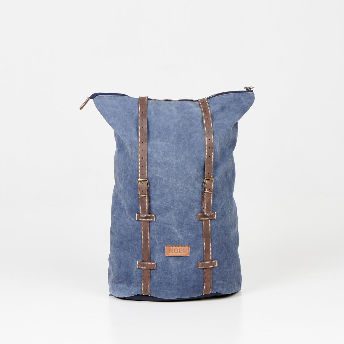 2. Back view of Noel ZIP Backpack in blue, highlighting leather straps and canvas material