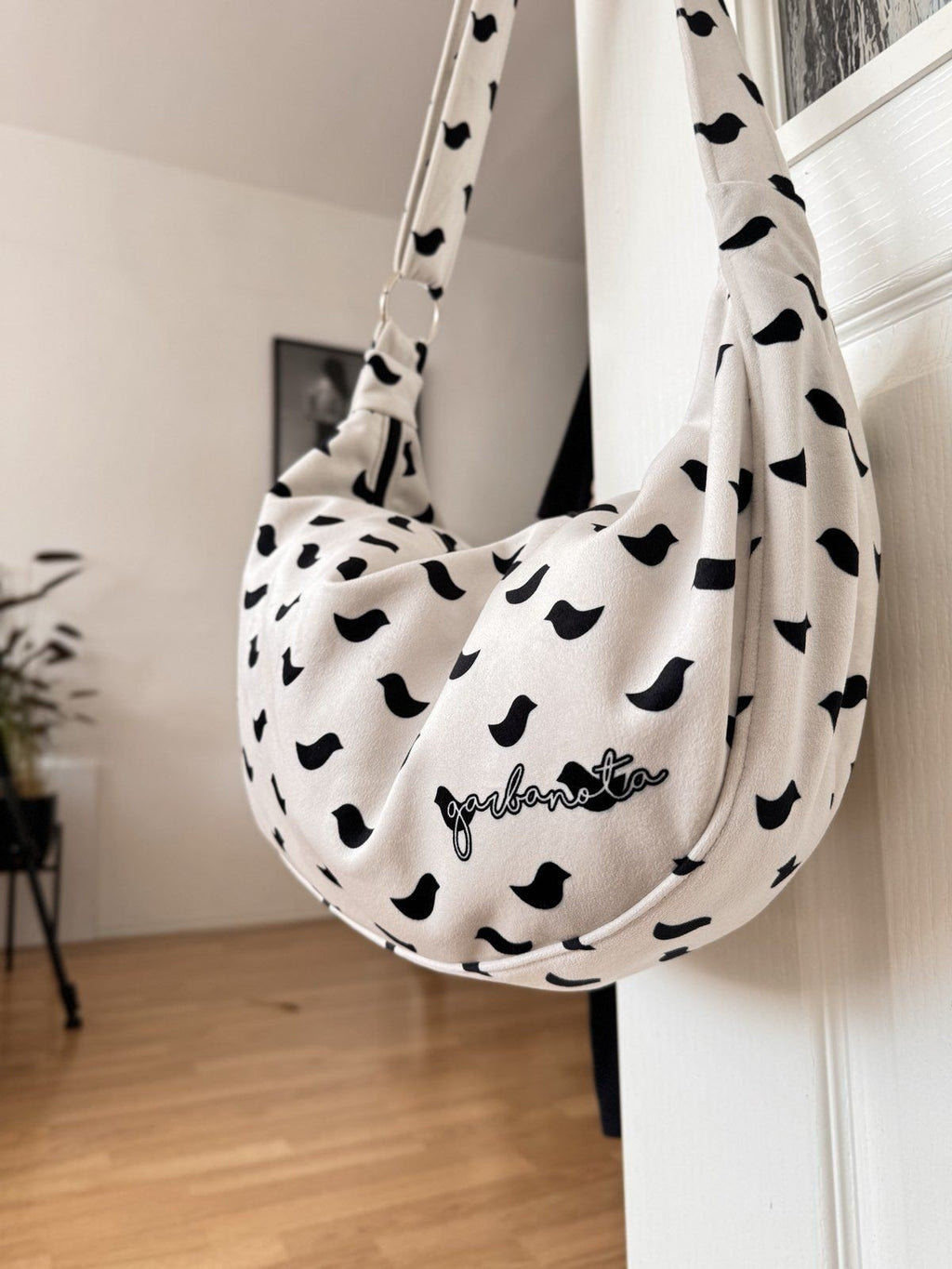 6. Close-up of Garbanota Hobo Bag Birds in white with black bird pattern, showing soft velour material