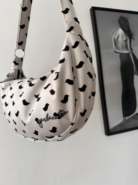 5. Close-up of Garbanota Hobo Bag Birds in white with black bird pattern, highlighting brand logo