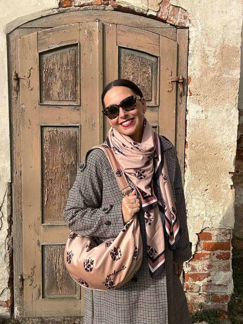 1. Woman wearing Garbanota Hobo Bag in Brown Leopard Tulips, styled with a scarf and coat, standing outdoors