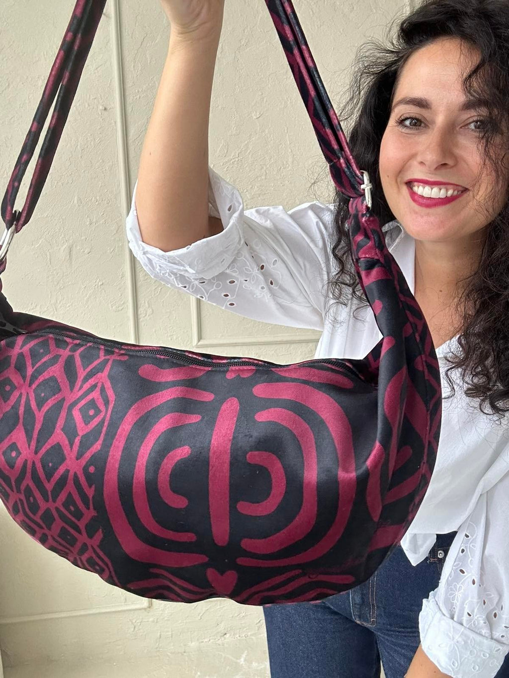 5. Close-up of woman holding Garbanota burgundy pattern hobo bag, emphasizing intricate pattern and soft texture