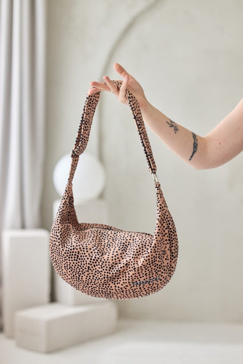 2. Garbanota cream and dots hobo bag with adjustable strap, shown in hand