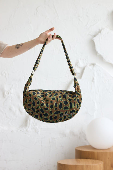 1. Garbanota Curly Leopard Hobo Bag in lifestyle setting, showcasing adjustable strap and leopard print design